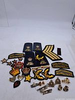 Full assortment of RCMP patches, badges, pins and chevrons laid out