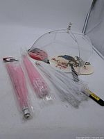 Lot overview showing open white food cover, packaged mesh covers, two fans, fly swatters