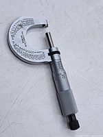 Full view of micrometer front, showing thimble, ratchet, frame scales