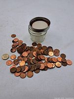 Coins spread out with jar shown