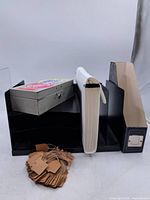 Group shot of all items: desktop file sorter, magazine holder, accordion file, metal tin, kraft tags