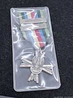 Obverse of medal with ribbon and Bolonia & Monte Cassino bars in plastic sleeve