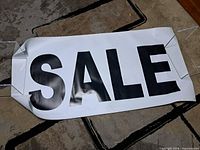 Full view of the PVC vinyl SALE banner on floor