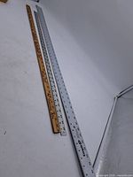 Three rulers laid out side by side