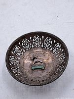 Top view of pierced sterling silver bowl with badge inside