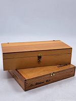 Two wooden cigar boxes stacked, showing sizes and latches