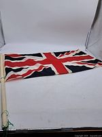 Full view of Union Jack flag attached to wooden pole