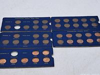 Overall view of four blue album panels with coins in slots