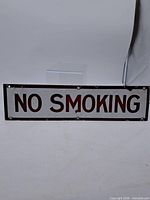 Full view of enameled metal "NO SMOKING" sign