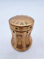 Angled view showing domed top stamped H.M.C.S. MINAS and fluted brass body