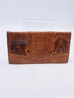 Front view of brown reptile-pattern leather clutch wallet