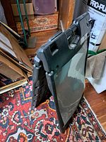 Folded black plastic A-frame signboard showing both halves and clear panel