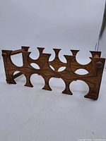 Full view of wooden wine rack showing eight cut-outs