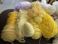 group of pastel yarn skeins and balls