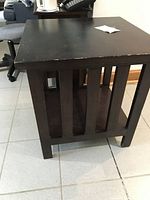 End table angled view showing slatted sides and lower shelf