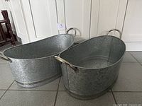 Overall view of both matching oval metal tubs