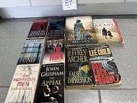 Full group of ten paperback novels laid flat