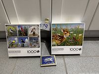 Front view of both puzzle boxes and playing card deck