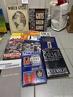 All nine books laid out on floor, titles visible