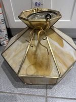 Full view of octagonal stained glass ceiling lamp with wiring and socket visible