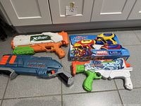 All four water blasters arranged on floor