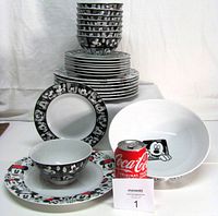 Stacked bowls and plates with serving bowl showing Mickey pattern