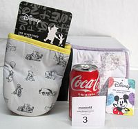 Both packaged Disney 2-pack oven mitt sets and size reference soda can