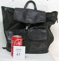 Front view of black leather backpack with Coke can for scale
