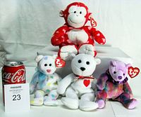 Front view of all four Ty plush with size reference can