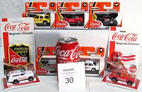 All seven vehicles and two magnets arranged with reference can and lot card