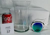 Lot overview showing vase and fish figurine next to size reference