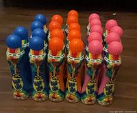 Front view of 24 Dab O Ink markers grouped by color