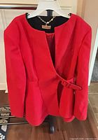 Front view of red blazer on hanger