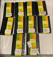 Front view of ten sealed Baran business card holder books showing label and capacity info