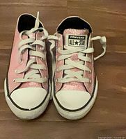 Top view of both sneakers showing uppers, laces, logo tongue tag