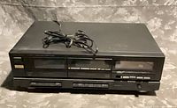 Front angled view of Fisher CR-W911 dual cassette deck with attached power cord