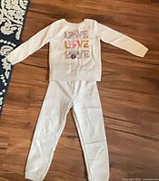 Full view of sweatshirt and pants laid flat