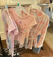 Four garments on hangers—three nightgowns and one plush robe