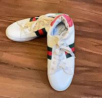 Top view of both Gucci sneakers showing laces and side stripes