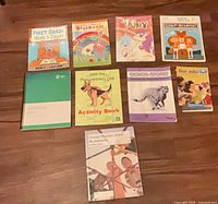 All nine visible books laid out on floor