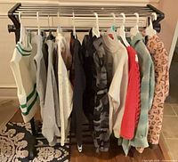 Full view of all ten tops hanging on rack