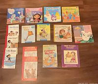 All 15 books laid out on wooden surface, titles visible