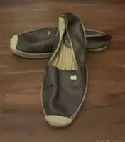 Top view of both flats showing uppers, MK logos, and interior