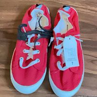 top view of both sneakers showing color, laces, hang tag