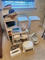 Group view of hampers, shelf with towels and accessories