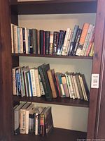 Full view of three bookshelf shelves filled with books