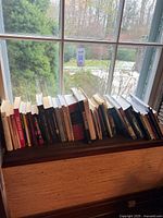 Full span of books on window ledge