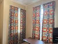 Two windows displaying patterned curtain sets