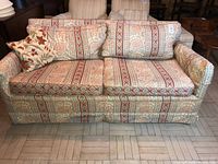 Front view of patterned fabric sofa with cushions