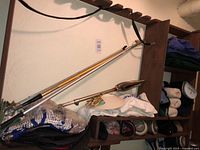 Shelf with two telescoping golf ball retrievers, caps, towel, accessories